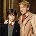Glideroy Lockhart holds Harry Potter close to take a picture for the Daily Prophet