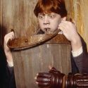 Ron Weasley holding a bucket while he throws up slugs