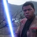 Finn from Star Wars ignites a blue lightsaber