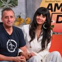 Joe Gatto and Jameela Jamil sitting together on a couch on a news morning show
