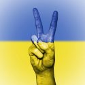 Picture of Ukrainian colors (blue and yellow) with a hand making the peace sign
